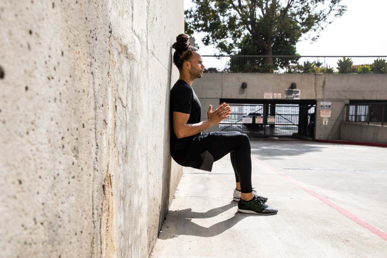 Young afroamerican man getting fit in Los Angeles downtown city streets, USA.